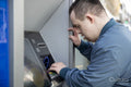 Man using cash machine in street