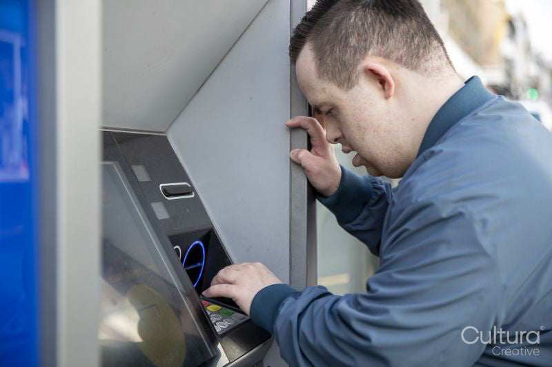 Man using cash machine in street