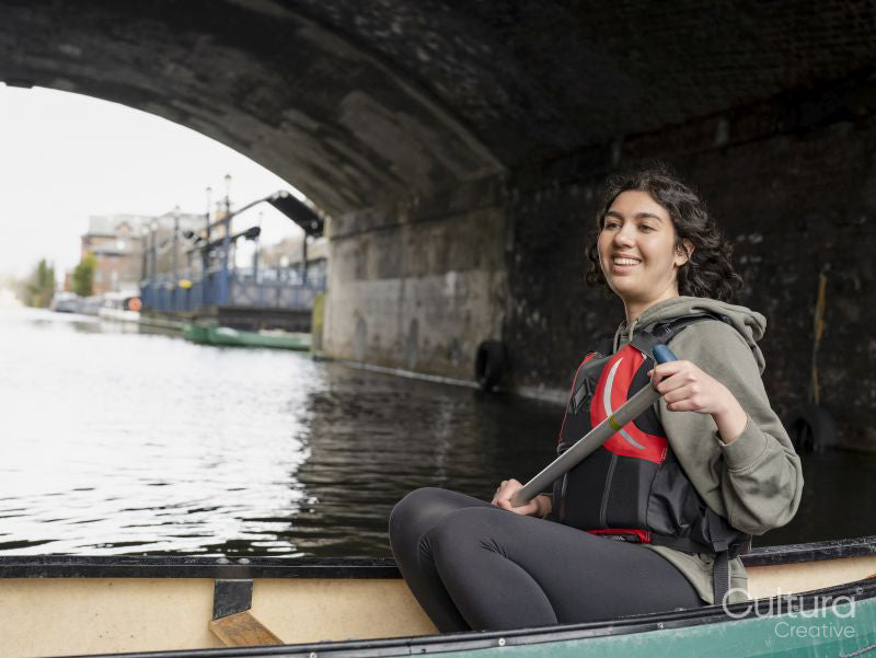 Smiling young woman in canoe