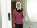 Sutton,Smiling woman in headscarf and sports clothing leaving house