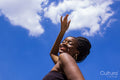 Portrait of young woman under blue sky