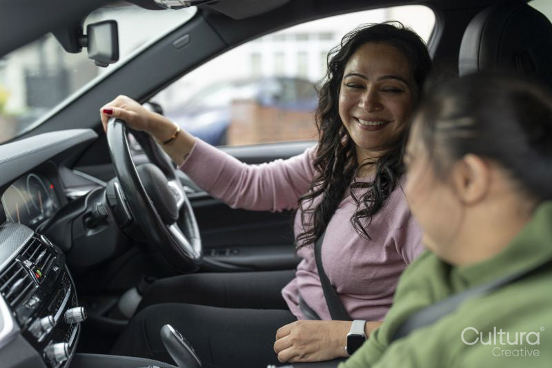 Mother driving car with down syndrome daughter