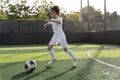 Girl playing soccer on soccer field
