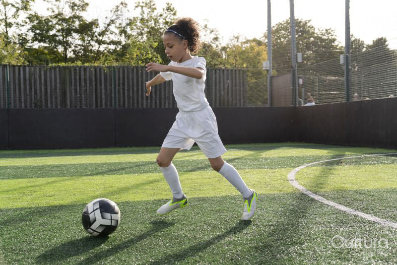 Girl playing soccer on soccer field