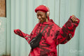 Smiling young woman wearing red dancing outdoors
