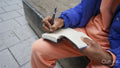 Close up of man writing in diary