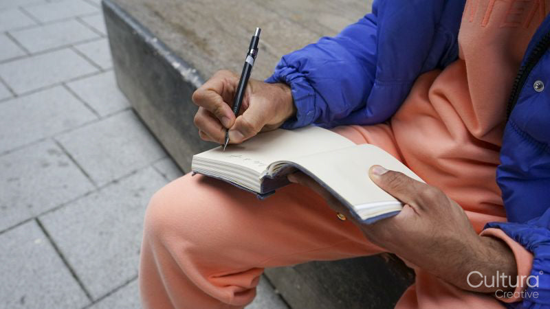 Close up of man writing in diary