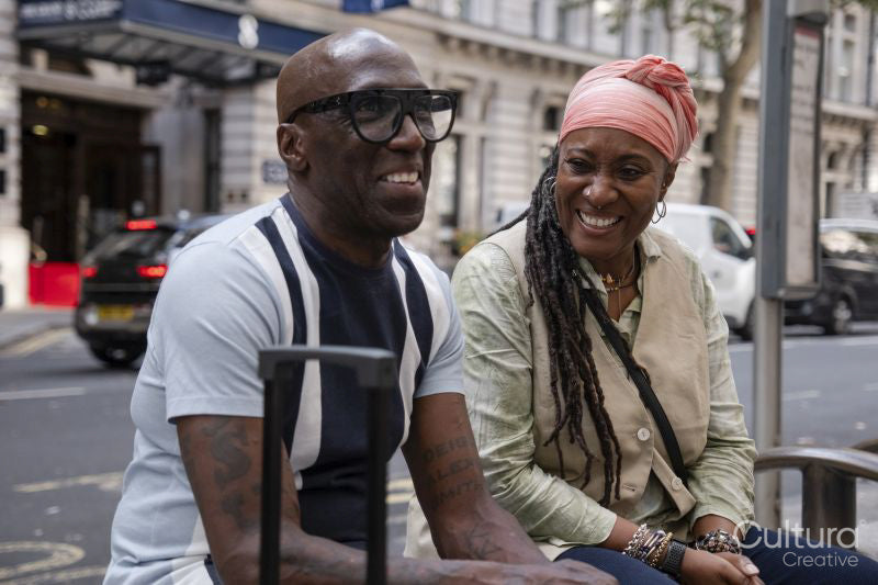 Happy mature couple sitting at bus stop