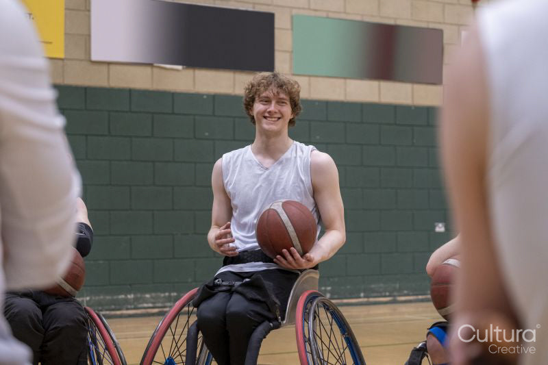 Smiling male basketball player in wheelchair
