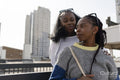 Young stylish female couple in city