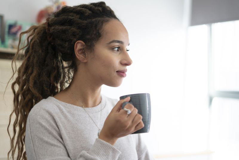 Woman drinking coffee at home