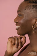 Profile view of smiling young woman wearing jewelry