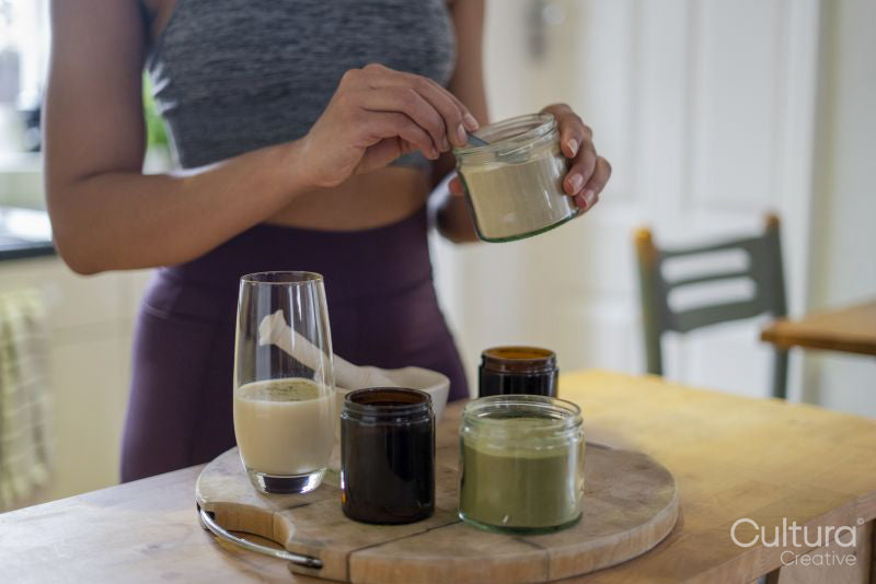 Woman preparing healthy drink at home