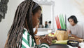 Mother and daughter praying before Kwanzaa meal