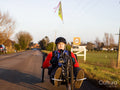 Disabled man riding handcycle on country road