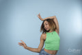Woman wearing green top, dancing